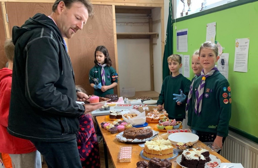 Derek eyes up a cake